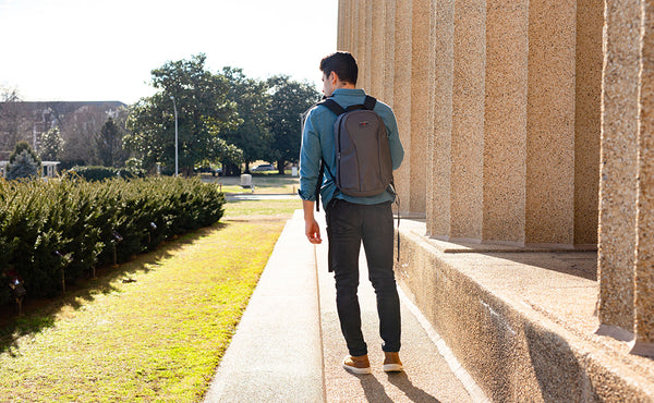 A person carrying the Luminary 15 via the backpack straps